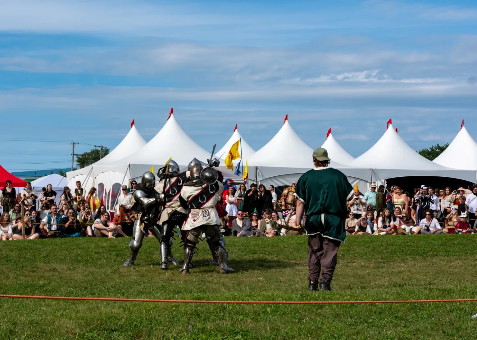 A packed crowd watches armoured fighters at the 2026 Faire